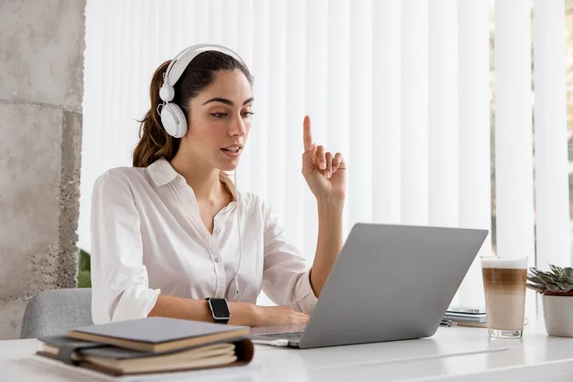 online education, video call, work environment, headphones, laptop, online meeting, young woman, remote worker, desk, office environment, working from home, teacher, online course, digital communication, coffee, work desk, distance learning, drinking coffee, raised finger. How flat, per-member, per-seat and usage pricing behave as a community grows