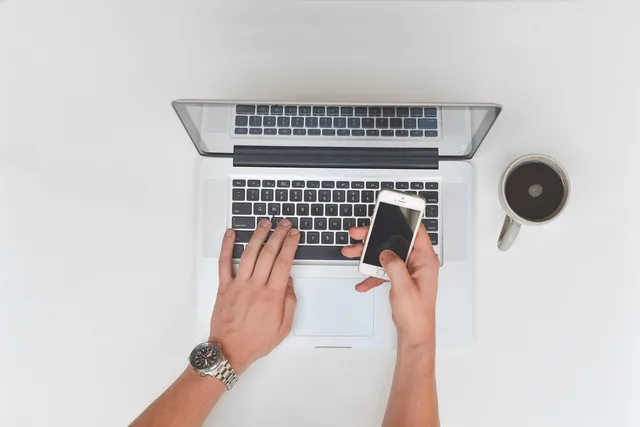 desk, computer, laptop, cup, coffee, hands, typing, cell phone, smartphone, call, work, coffee cup, office, business, table, technology, workplace, professional, communication. How to start an online community for UK freelance consultants